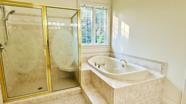 bathroom with tile patterned floors, separate shower and tub, and a wealth of natural light