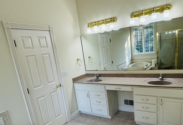 bathroom with tile patterned flooring, vanity, and independent shower and bath