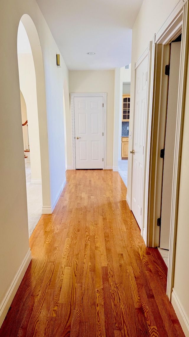 corridor with light wood-type flooring