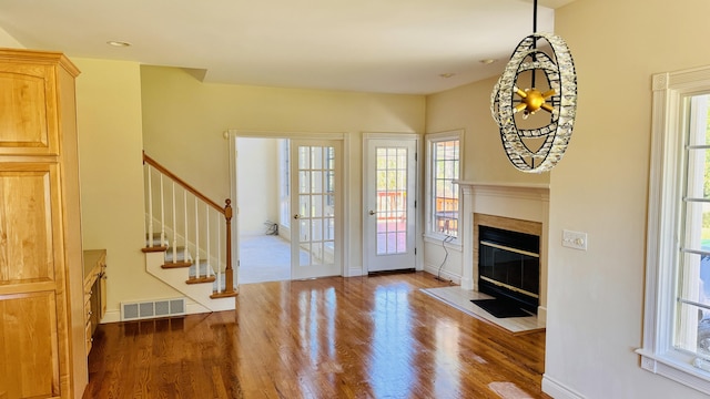 living room featuring a healthy amount of sunlight and dark hardwood / wood-style flooring