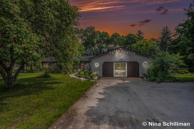 view of front of home featuring a garage and a yard