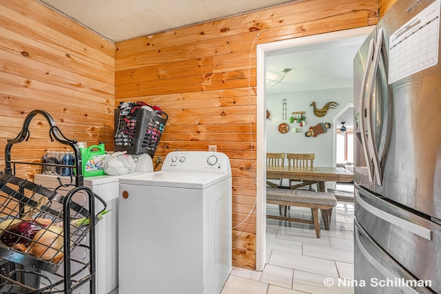 washroom featuring wood walls and washer / clothes dryer