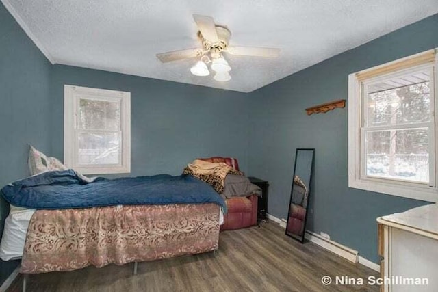 bedroom with ceiling fan, dark hardwood / wood-style flooring, and a textured ceiling