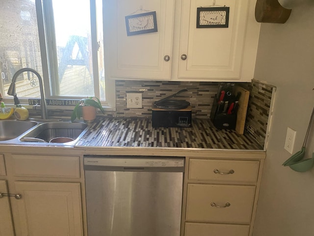 kitchen featuring dishwasher, backsplash, white cabinetry, and sink