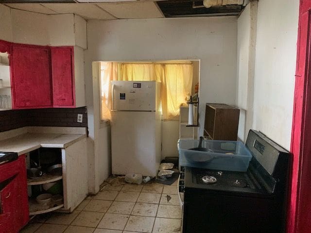 kitchen with washer / dryer and white refrigerator