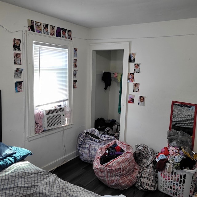 bedroom with cooling unit and dark hardwood / wood-style floors