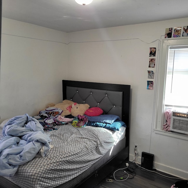 bedroom with hardwood / wood-style flooring and cooling unit