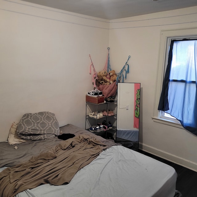 bedroom featuring hardwood / wood-style floors and multiple windows