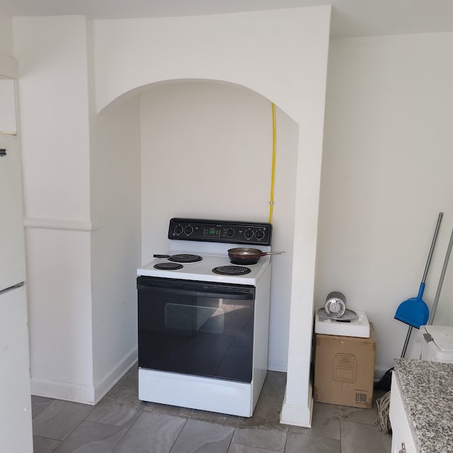 kitchen with range with electric stovetop and white refrigerator