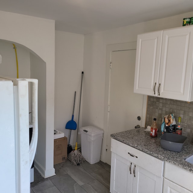 interior space featuring tile patterned flooring and backsplash