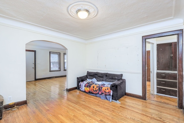 living area with a textured ceiling and light hardwood / wood-style floors