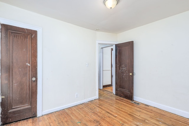 empty room with light hardwood / wood-style flooring