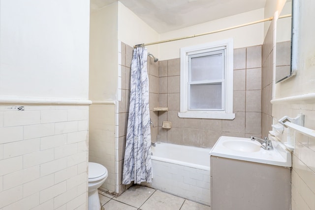 full bathroom with vanity, tile walls, tile patterned floors, and shower / bath combo with shower curtain