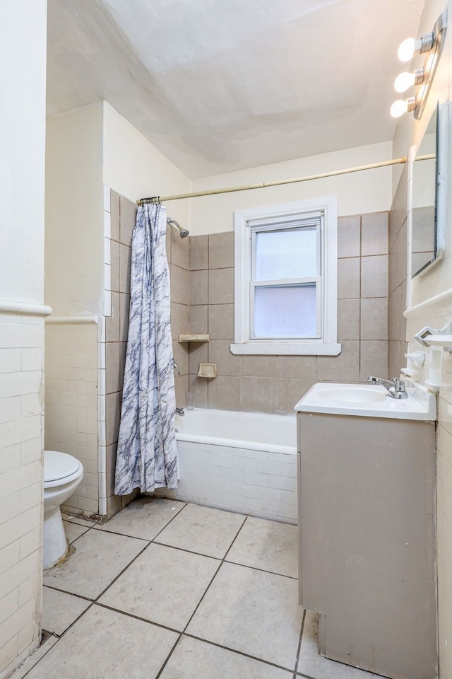 full bathroom with tile walls, vanity, toilet, shower / bath combo, and tile patterned floors