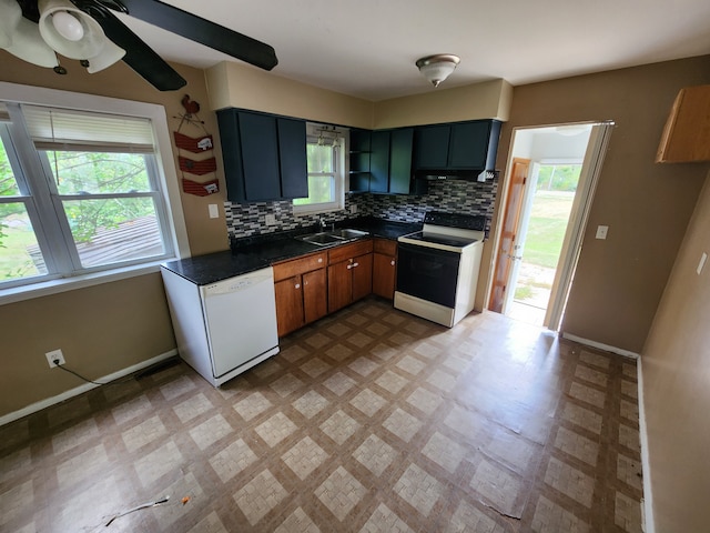 kitchen with backsplash, white appliances, sink, and a wealth of natural light