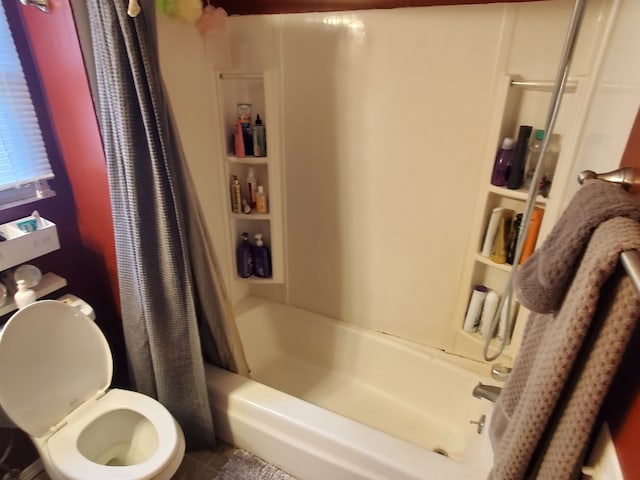 bathroom with tile patterned floors, shower / bath combo, and toilet