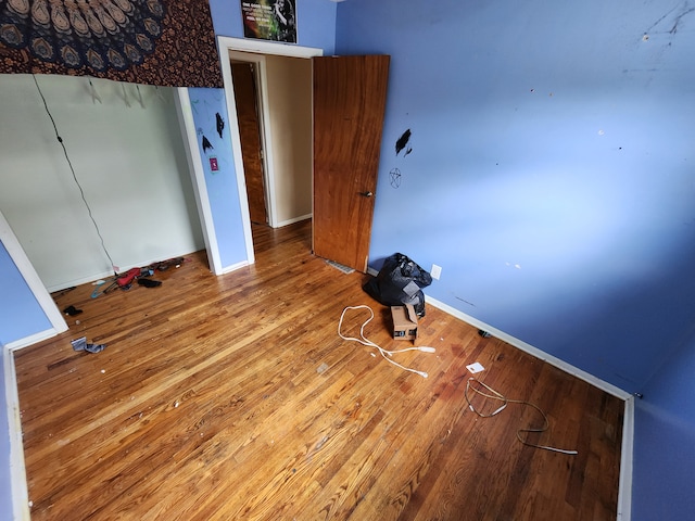 unfurnished bedroom with wood-type flooring