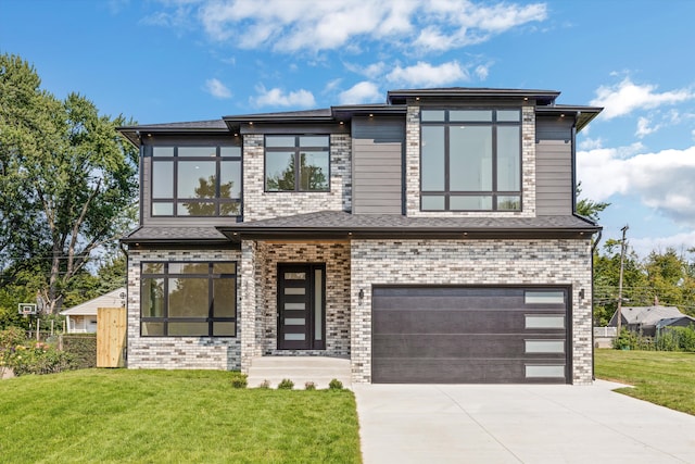 view of front of property featuring a garage and a front lawn