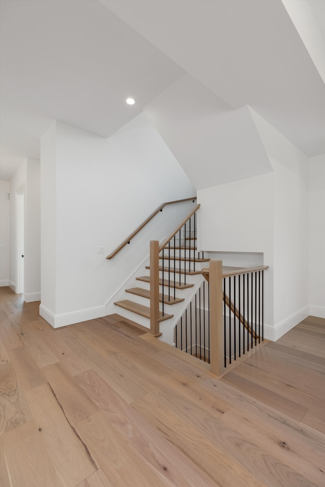 staircase with hardwood / wood-style flooring