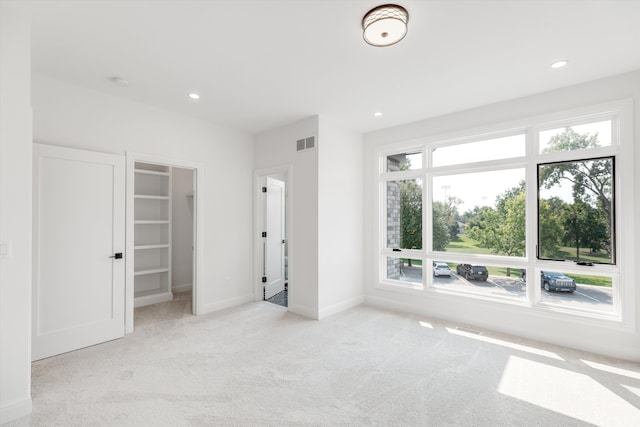 unfurnished bedroom with light colored carpet