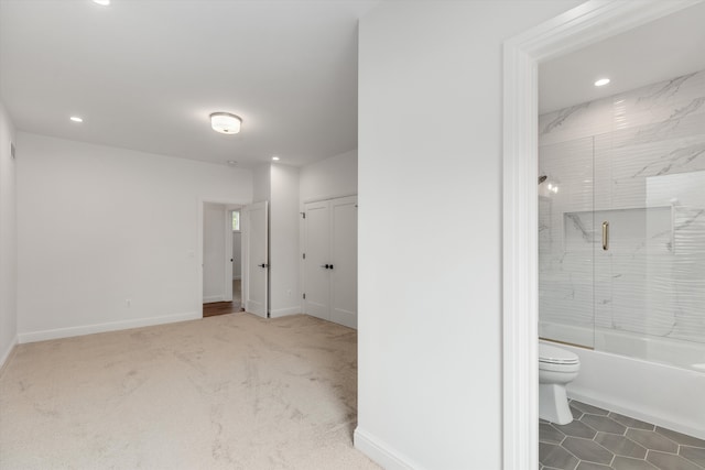 interior space featuring shower / bath combination with glass door and toilet