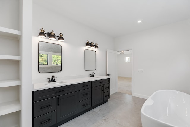 bathroom with a washtub and vanity