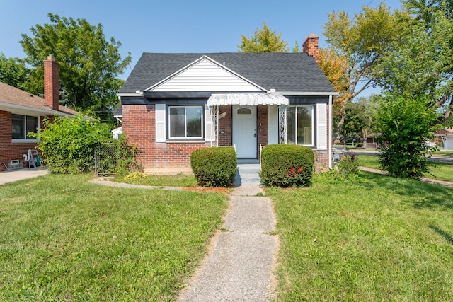 bungalow-style home with a front yard