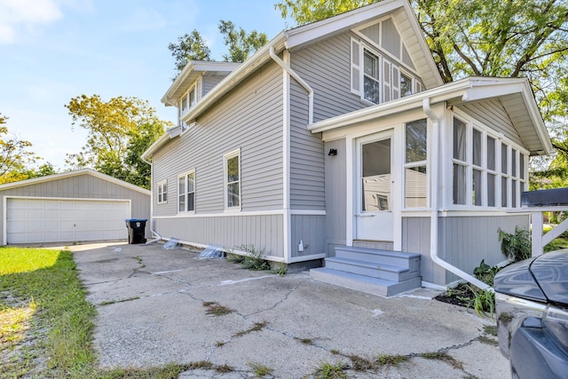 view of front of property featuring a garage and an outdoor structure