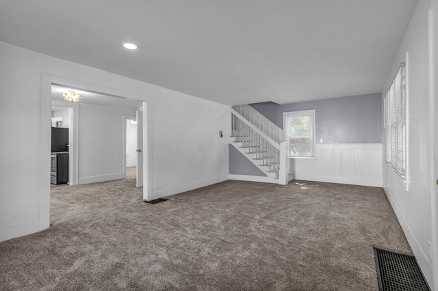 unfurnished living room featuring carpet floors