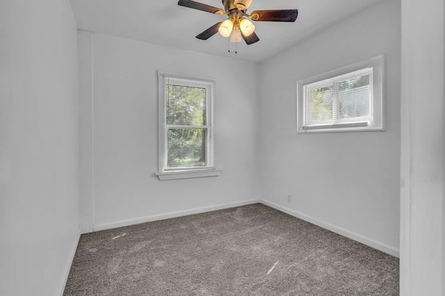 carpeted spare room featuring ceiling fan