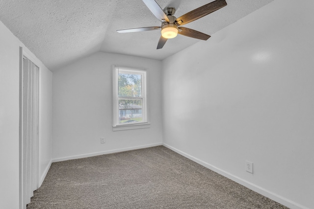 bonus room featuring ceiling fan, lofted ceiling, a textured ceiling, and carpet floors