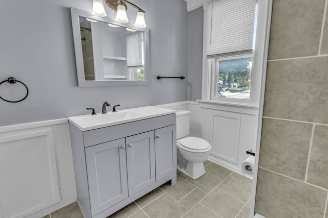 bathroom featuring tile patterned floors, vanity, and toilet