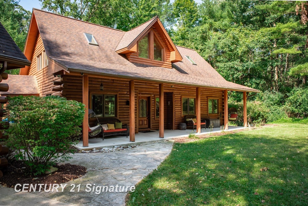 view of front facade with a patio area, a front lawn, and an outdoor hangout area