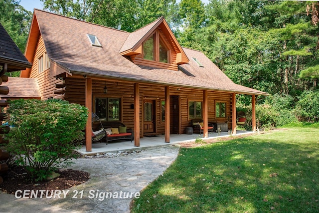 view of front facade with a patio area, a front lawn, and an outdoor hangout area