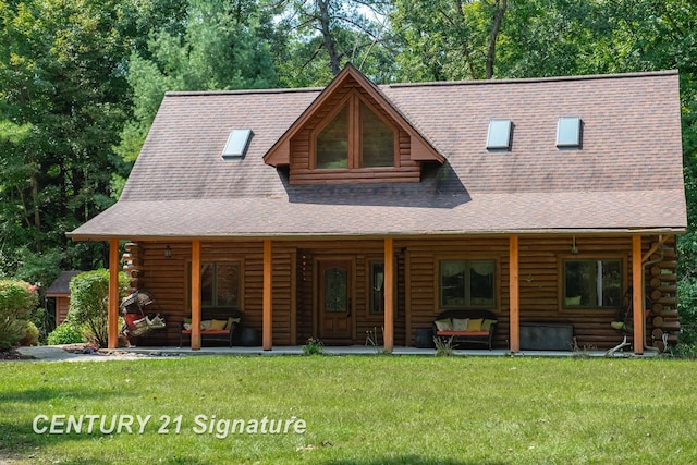 back of property with covered porch, a yard, and an outdoor hangout area