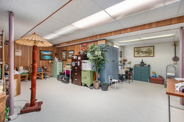 interior space with a paneled ceiling