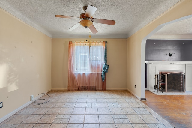 unfurnished living room with ceiling fan, a textured ceiling, and light hardwood / wood-style flooring