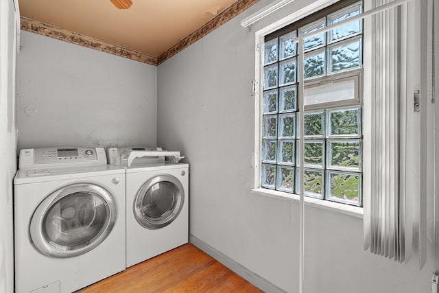 clothes washing area with light hardwood / wood-style floors and separate washer and dryer