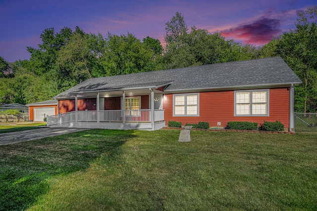 view of front of house featuring covered porch and a yard