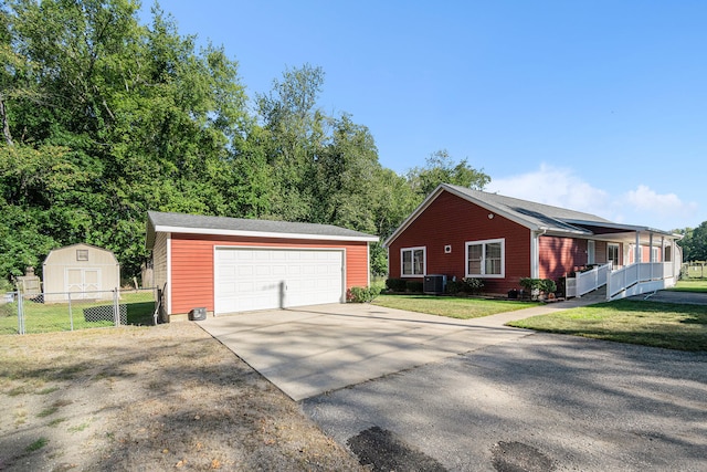 view of front of house featuring a front yard, a shed, and cooling unit