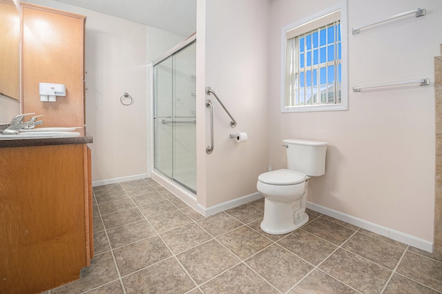 bathroom featuring toilet, tile patterned flooring, vanity, and walk in shower