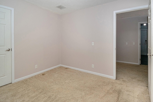 carpeted spare room featuring a textured ceiling