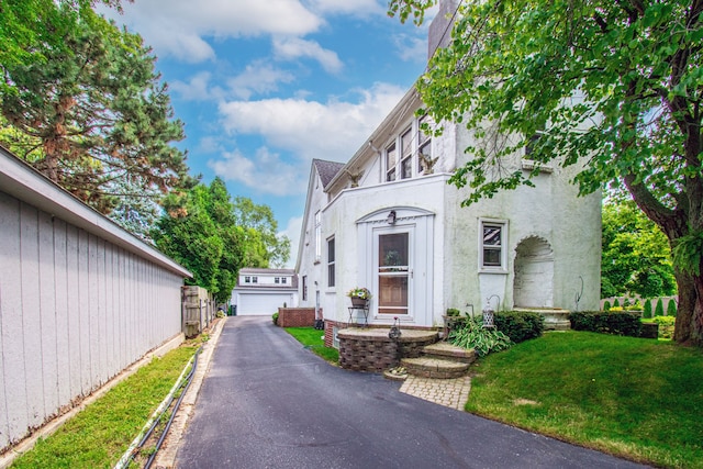 view of front of home featuring a garage and a front lawn