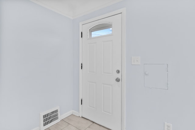 foyer entrance with light tile patterned floors and ornamental molding