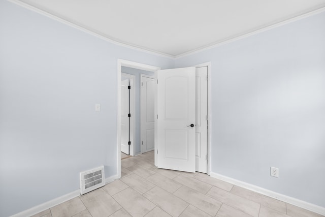 unfurnished room featuring crown molding