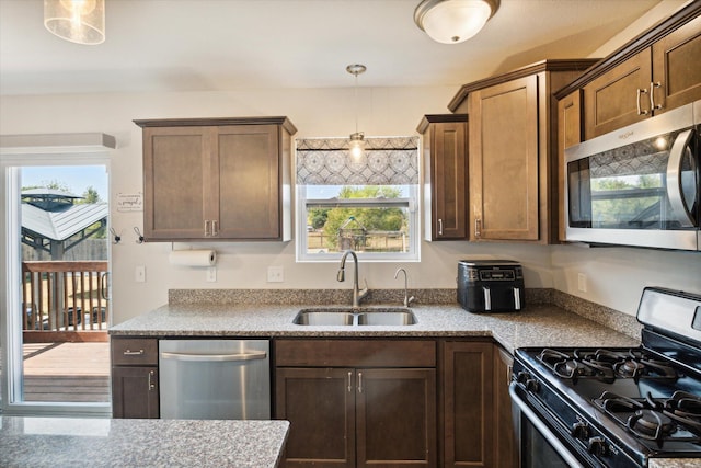 kitchen featuring sink, stainless steel appliances, and pendant lighting