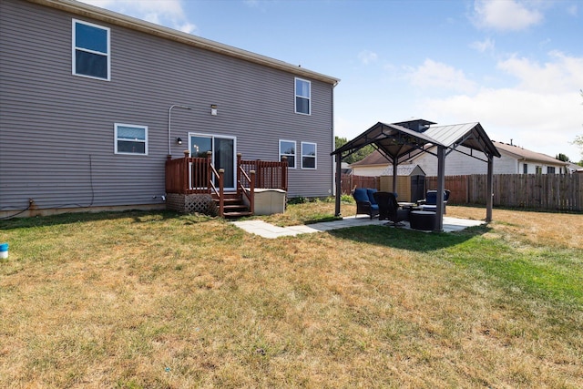 back of property with a gazebo, a lawn, and an outdoor hangout area