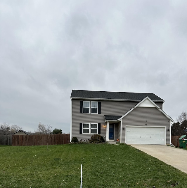 view of property featuring a garage and a front lawn