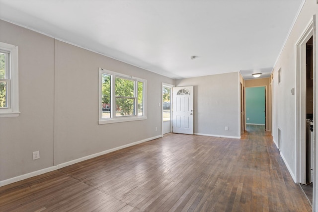 unfurnished room with plenty of natural light and dark hardwood / wood-style floors