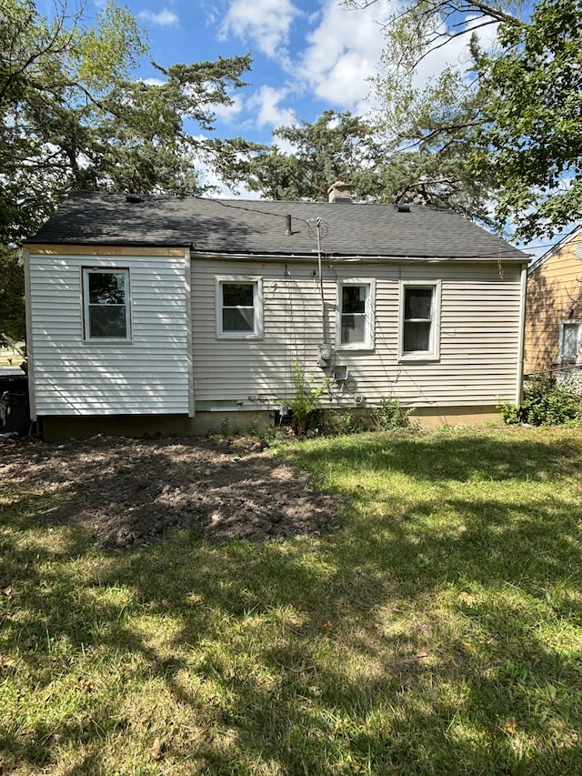 back of house featuring a lawn